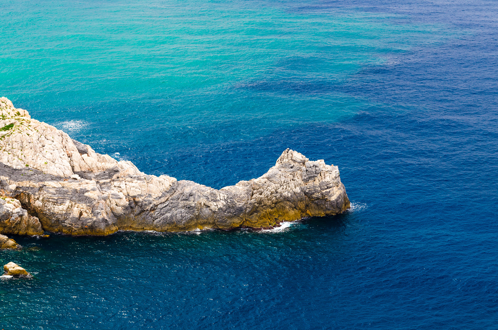 Cliff rock of Lord Byron Parque Natural park De Portovenere town among waves of turquoise and blue water of Ligurian sea, Riviera di Levante, La Spezia, Liguria, Italy, close-up