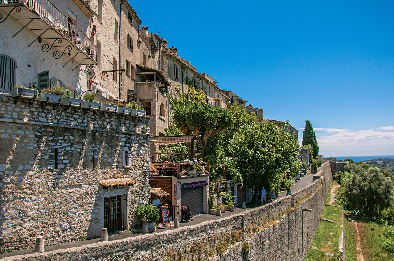 Panoramic view of wall, houses and shops in Saint-Paul-de-Vence.