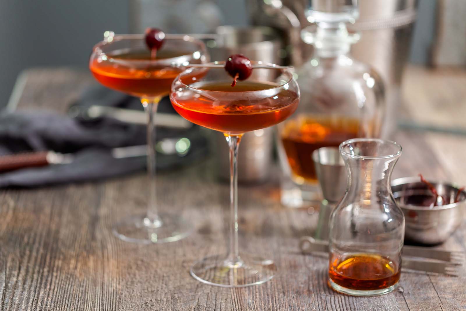 Manhattan cocktail garnished with brandied cherry.