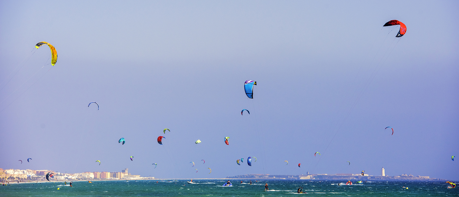 Large group of kitesurfers at sea
