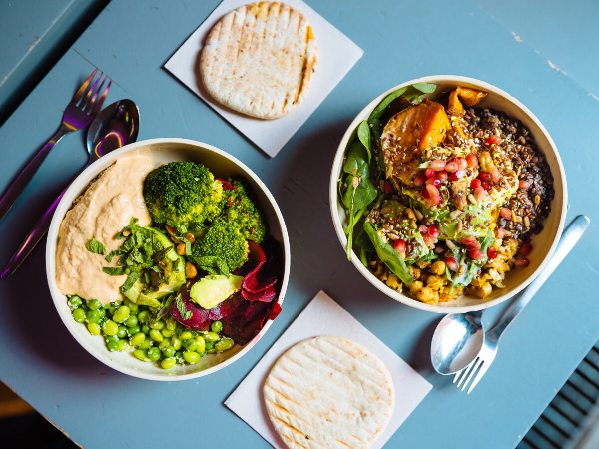 Vegan bowls with various vegetables and seeds, high angle view