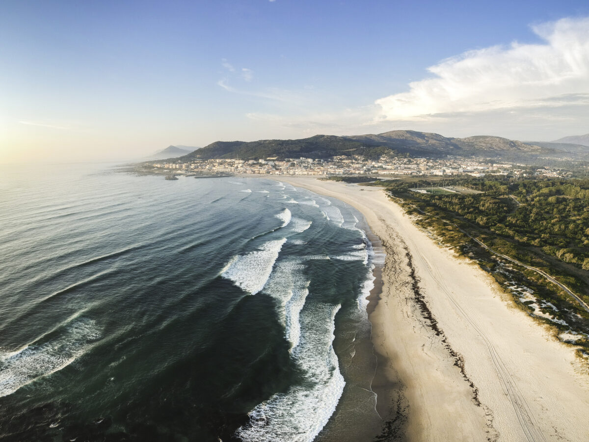 Aerial view of waves approaching the pristine coastline at Vila Praia de Âncora, Portugal