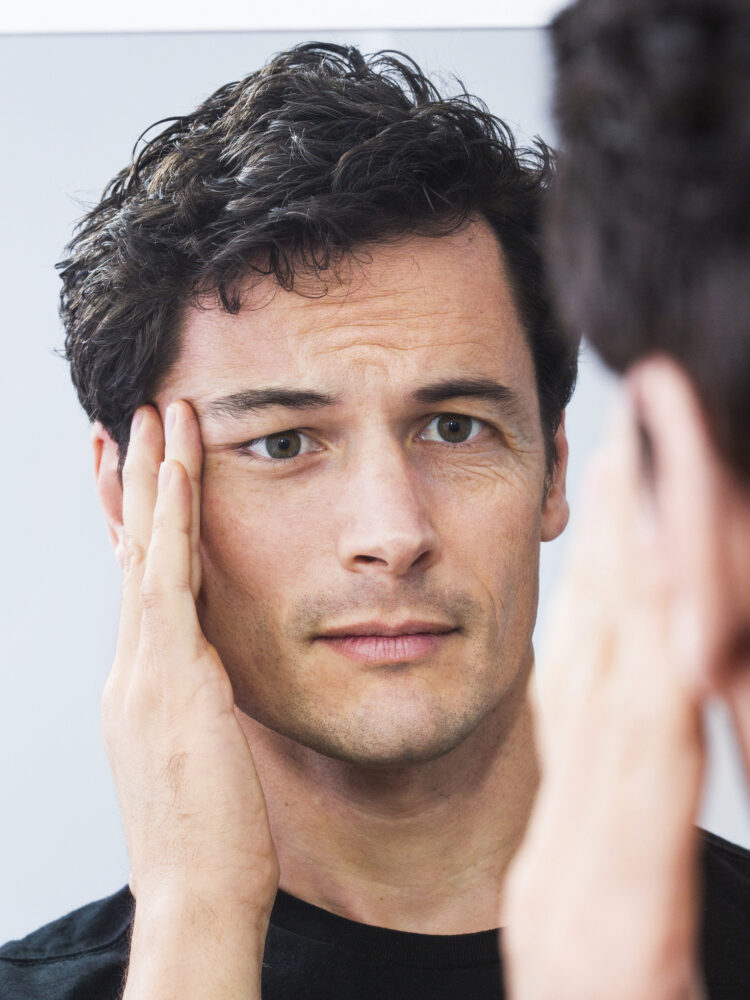 Man pulling one side of his face, facelift or not?