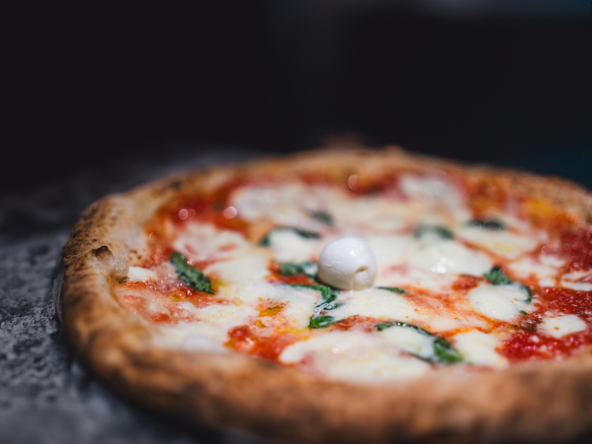 Original Pizza Margherita in a traditional Pizzeria, Naples, Italy. pizza